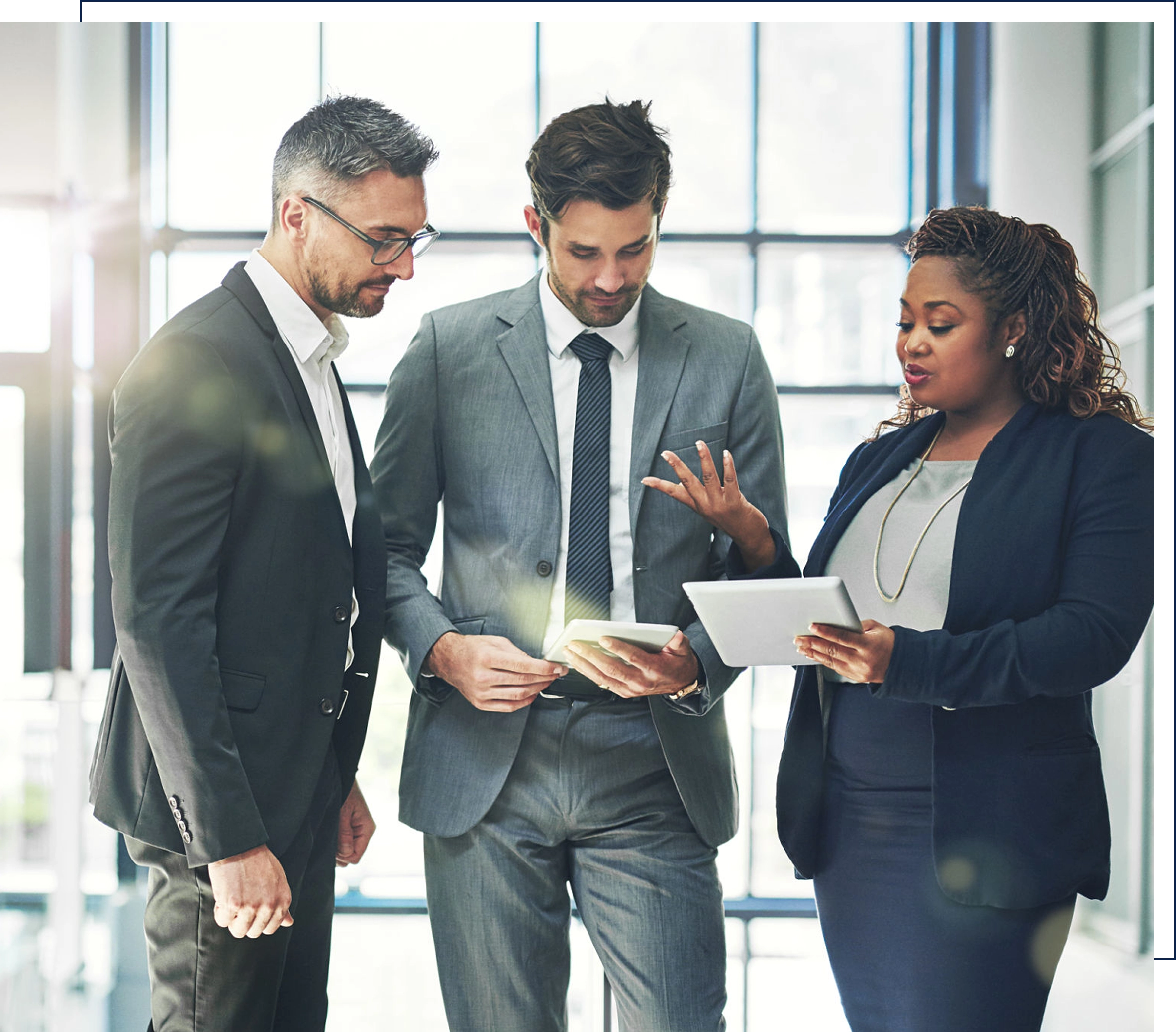 A man in office with colleagues working.
