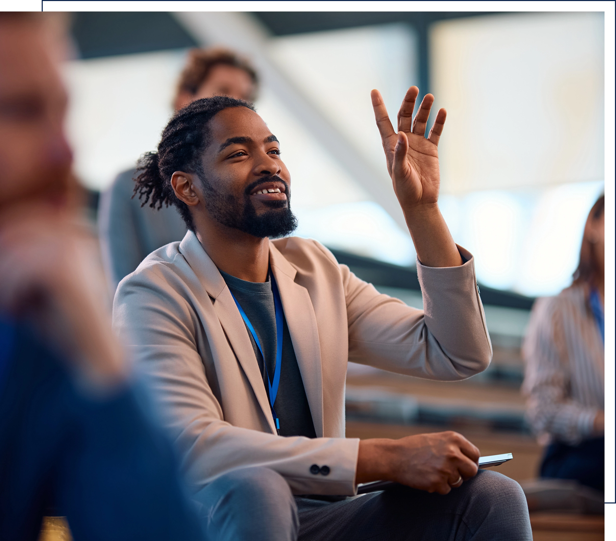 Man raising hand in a meeting.